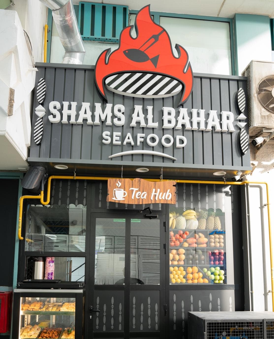 The Shams Al Bahar Seafood storefront and flame logo sign in Abu Dhabi
